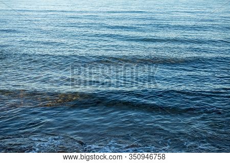Calm Waves On The Shore Of The Blue Sea