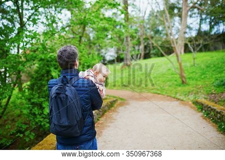 Father Carrying His Shild During Walk In Park. Man With His Adorable Toddler Daughter Enjoying Natur
