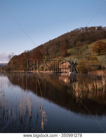 Stunning Sunrise Autumn Fall Landscape Image Of Ullswater In Lake District With Golden Sunlight