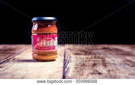 Perth, Scotland - 11 November 2019: Pesto Made Of Sundried Tomatoes Isolated On Vintage Wooden Board