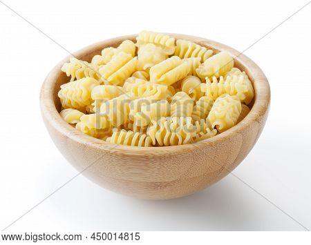 Uncooked Radiatori Pasta In Wooden Bowl Isolated On White Background With Clipping Path