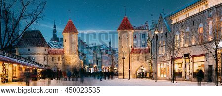 Tallinn, Estonia. Night Starry Sky Above Famous Landmark Viru Gate Gates. Street Lighting In Winter 