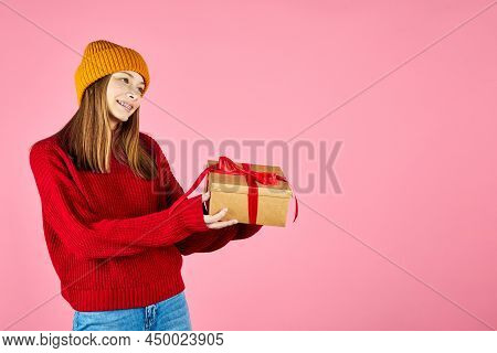 Young Smiling Happy Hipster Girl With Baces Giving Present Boxes Celebrating New Year, Wearing Red K
