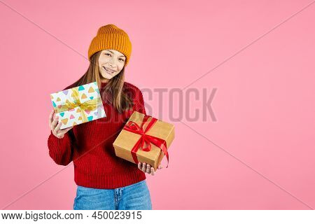 Young Smiling Happy Hipster Girl With Baces Holding Present Boxes Celebrating New Year, Wearing Red 