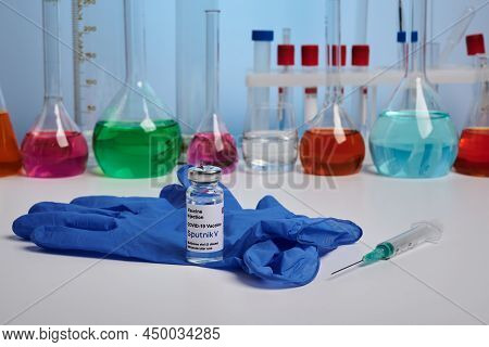 Krasnoyarsk, Russia - February 04, 2022: Sputnik - V Covid Vaccine And Glove On Chemical Desk. Photo