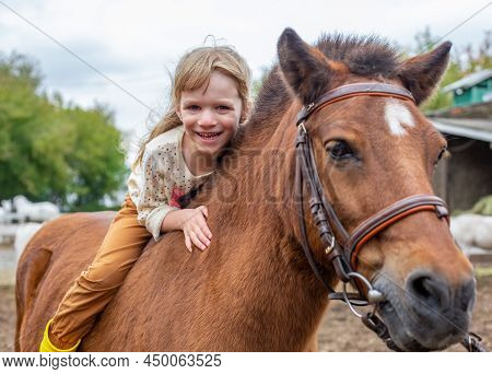 Happy Little Girl Riding Pony Horse Bareback And Laugh