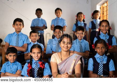 Happy Smiling Kid With Teacher Prepared For Class Group Photo Or Picture At Classroom By Looking At 
