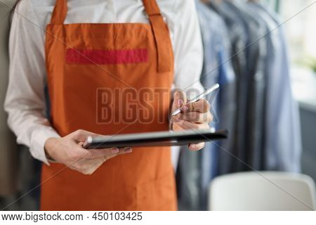 Close-up Of Dry Cleaning Company Worker In Uniform Take Order, High Quality Service, Washing Clothin