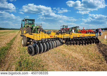 Bilogirya, Khmelnytsky Region, Ukraine - August 19, 2021: Tractor With Disc Harrow In Operation At T