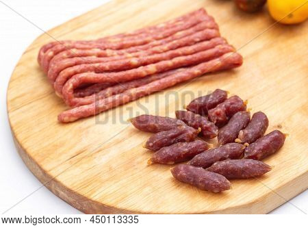 Smoked Beer Snack Thin Mini Sausages Wooden Background. Close-up