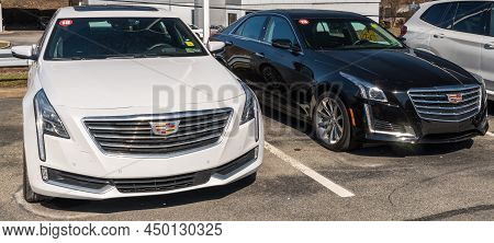 Monroeville, Pennsylvania, Usa February 27, 2022 Two Used Cadillac Sedans, One White And One Black T