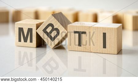 Four Wooden Blocks With The Letters Mbti On The Bright Surface Of A Gray Table, Business Conceptual