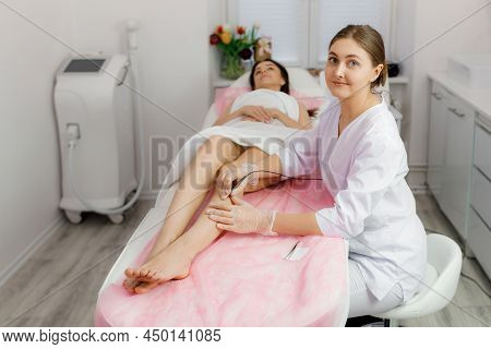 Dermatologist Doing Hair Removal Treatment On Patients Leg With Electrolysis. Depilation And Beauty 