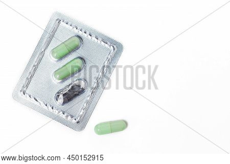 Green Chiretta Herbal Capsule On White Background With Copy Space For Healthcare And Medical Concept