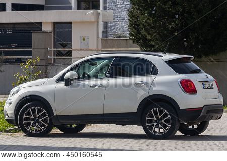 Side; Turkey - February 01 2022:   White Fiat 500x  Parked On The Street On A Warm Summer Day Agains