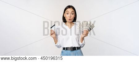 Finance And Money Concept. Happy Young Asian Woman Dancing With Cash And Credit Card, Smiling Please
