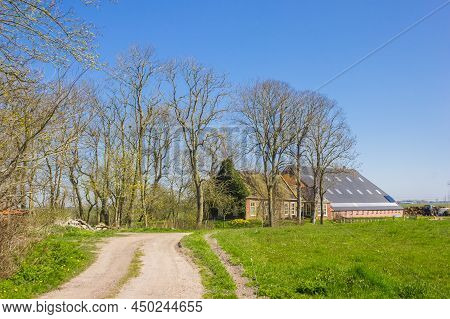 Dirt Road Leading To A Historic Farm In Fransum, Netherlands