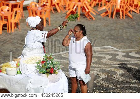 Salvador, Bahia, Brazil - January 25, 2015: Candomble Adept Receives A Spiritual Bath From A Prieste