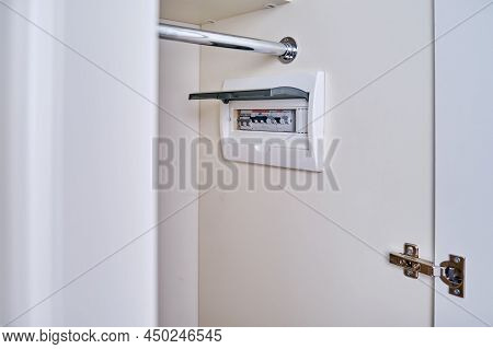 Automatic Fusein A Home Electrical Panel In The Closet With Clothes. Electricity Equipment In The Ap
