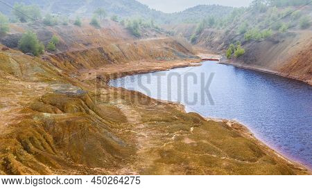 Shore Of Toxic Red Lake In Open Pit Of Abandoned Copper Mine Near Sia, Cyprus