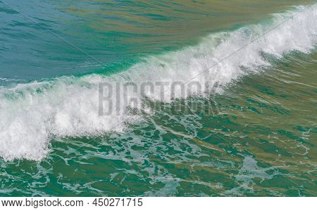 Surf Waves With White Water Crests Rolling In At Tolaga Bay, New Zealand.
