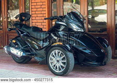 Side, Turkey - February 16 2022: A  Black Motorcycle Brp Can-am Spider Stands In A Parking Against T