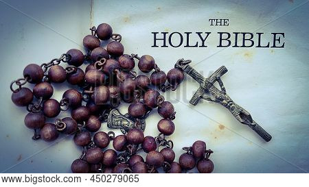 Top View Of Holy Bible Text With Rosary On Old Bible.