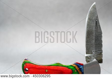 Hand-forged Knife Made Of Several Layers Of Steel With An Exclusive Pattern Photographed In The Stud