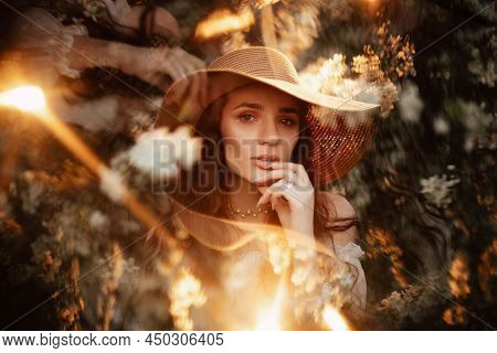 Portrait Of A Romantic Girl In A Blooming Garden With Elements Of Phantasmagoria.