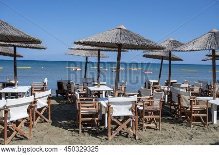 Beach Unbrellas And Chairs On Sunny Sandy Beach Lady's Mile In Akritori, Cyprus