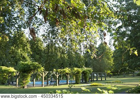 Grantham, England - July 23, 2014. Paddling Pool, Wooden Structure And People In Wyndham Park.