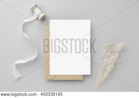 Blank Greeting Card Invitation Mockup 5x7 On Brown Envelope With Dried Flowers On Beige Background, 