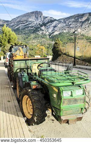 Benimantell, Alicante, Spain- November 27, 2021:farm Tractor Parked On The Street In Benimantell. Mo