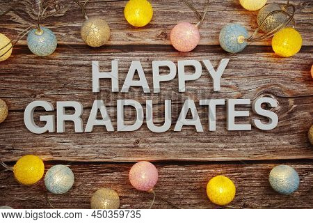 Happy Graduation Text With Led Cotton Balls Decoration On Wooden Background