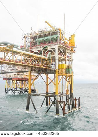 Group Of Steel Jacket Platform Rigs With Piled Legs Attach To Ocean Floor And Drilling Jackup Equipm