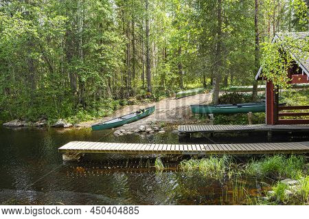 Wooden Boat Pier And Canoe On The Shore Of The Canyon Lake Julma-olkky, Hossa National Park, Kuusamo