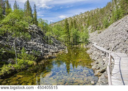 View Of The Pyha-luosto National Park In Summer, Rocks, Stones, Trees, Wooden Walkway And Natural Po