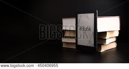 E Reader. Digital E Book, Library Reader Tablet With Books On Dark Background. Online Education Cour