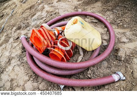 Construction Hose, Water Canister And Orange Cones Are On The Ground Again