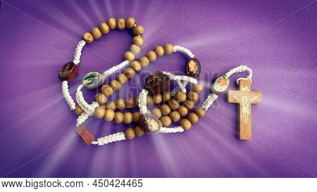 Holy Rosary On Purple Background. Christian Prayer Concept