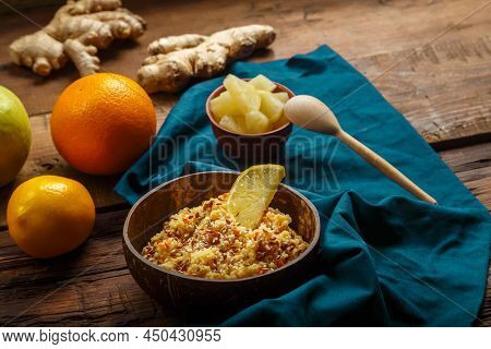 Couscous Masfouf With Dried Fruits And Nuts In A Plate On A Blue Napkin On A Wooden Table Next To Fr