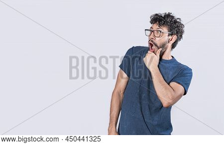 Amazed Young Man With Hand Near Open Mouth, Man Looking Aside With Face Scared Expression, Surprised