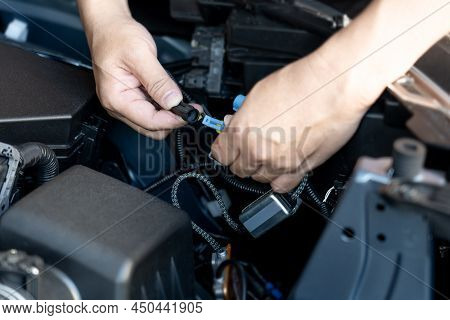 Close Up Hand A Man Hold Plug Of Car Headlight Bulb Check For Regularities And Accuracy Before Assem