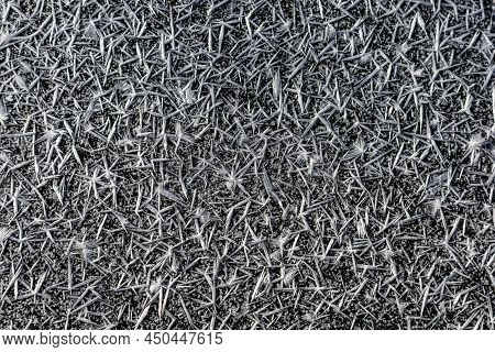 Ice crystals forming on surface of frozen pond