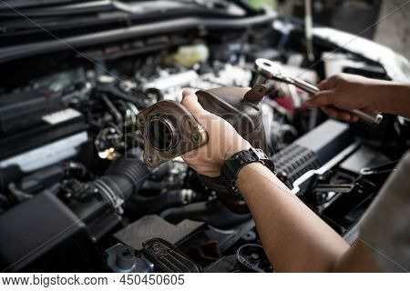 Close Up Old Catalytic Converter In Hand Car Service Man And Holding A Wrench For Remove Part In Eng