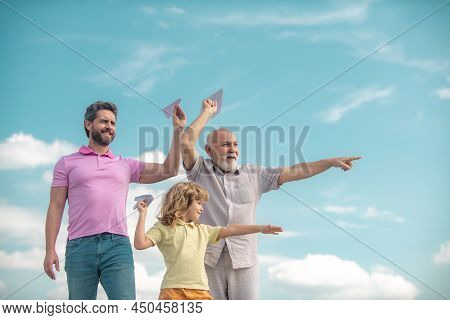 Grandfather Father And Son Playing With Toy Plane Outdoors On Sky. Happy Family. Three Men Generatio