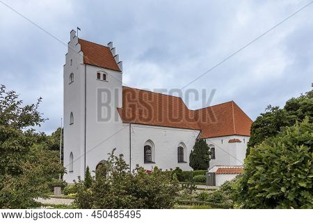 White Scandinavian Church With A Tall Tower And A Orange Tile Roof Against The Blue Sky, Orslev, Den