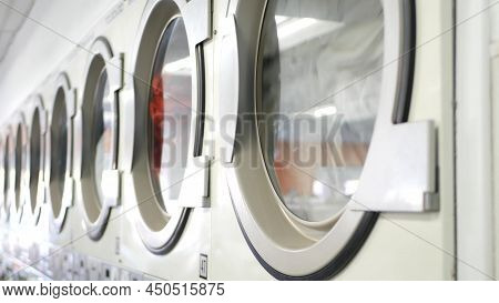 Row Of Washing And Drying Machines, Public Coin Laundry In California, Usa. Drums Of Washers And Dry