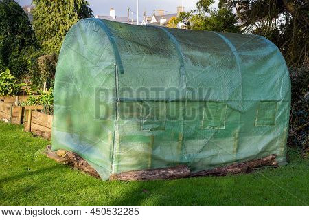 Large Protective Net Greenhouse With Roll-up Windows And Door In Organic Vegetable Garden With Raise