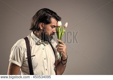 Confident And Elegant Man Hold Tulip Flowers. Gift For Love Date. Old Fashioned Bearded Hipster With